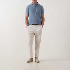 Model wearing Profuomo Garment-Dyed Polo Shirt in Grey Blue, styled with cream trousers and suede desert boots