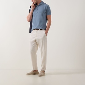 Model wearing Profuomo Garment-Dyed Polo Shirt in Grey Blue, styled with cream trousers, brown belt, and beige espadrilles.