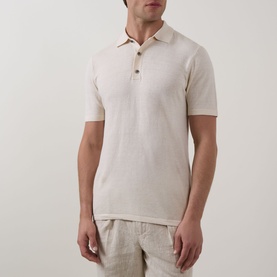 Model wearing Profuomo Solid Knitted Polo Shirt in Off White, linen-cotton blend with polo collar and button fastenings, styled with linen trousers