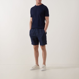 Model wearing Profuomo Solid Knitted T-Shirt in navy, styled with matching navy shorts and white trainers.