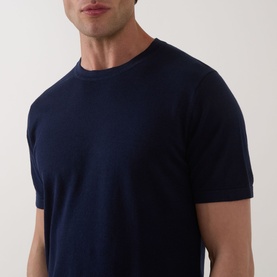 Model wearing Profuomo Solid Knitted T-Shirt in navy, featuring a round neck and short sleeves in a linen-cotton knit fabric.
