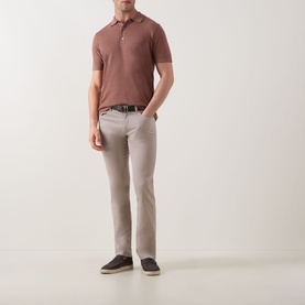 Model wearing Profuomo Solid Knitted Polo Shirt in clay with light grey trousers, brown belt, and dark navy shoes.