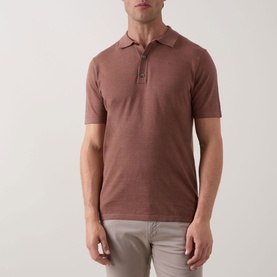 Model wearing Profuomo Solid Knitted Polo Shirt in clay, polo collar, short sleeves, button fastenings, styled with light grey trousers