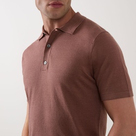 Model wearing Profuomo Solid Knitted Polo Shirt in clay, featuring polo collar, button fastenings and short sleeves in linen-cotton knit