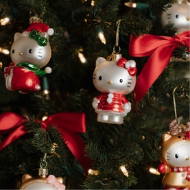 Vondels Hello Kitty Christmas tree ornaments in festive red and white, styled on a decorated green tree with red ribbon bows.