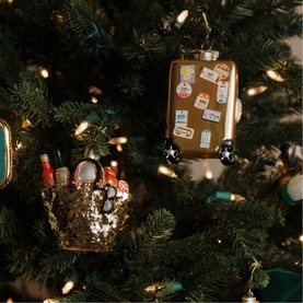 Vondels gold travel suitcase and beauty basket Christmas tree ornaments with stickers and glitter detail, hanging on decorated tree