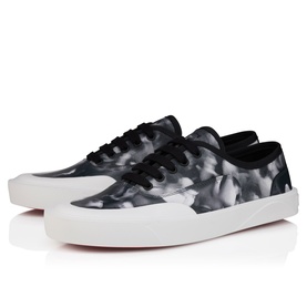 Christian Louboutin black and white marble-print low-top lace-up trainers with white rubber sole, shot from a three-quarter angle