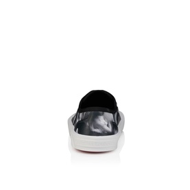 Christian Louboutin slip-on trainer in black and white marbled print, black heel collar, white sole, rear view.