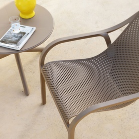 Caseys Furniture Net Garden Lounge Set Tortora in grey, fiberglass polypropylene armchair with perforated seat beside matching side table, outdoors