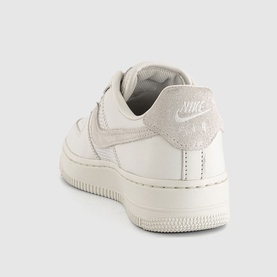 Nike trainer in Phantom white leather with tonal suede heel panel, cream sole, rear three-quarter view