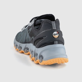 Nike men's trainer in cool grey, rear view showing textured sole, gum rubber outsole and Air unit heel detail