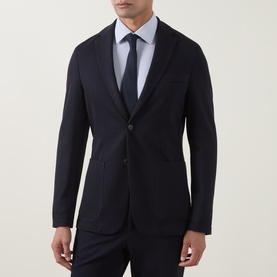 Model wearing Hugo Boss dark blue slim-fit blazer jacket, styled with light blue shirt and navy tie