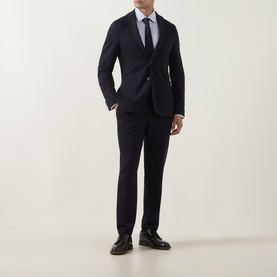 Model wearing Hugo Boss dark blue suit jacket with matching trousers, light blue shirt, navy tie, and black leather shoes.