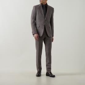 Model wearing Hugo Boss dark brown wool blend suit with slim-fit trousers, styled with black turtleneck and black leather shoes.
