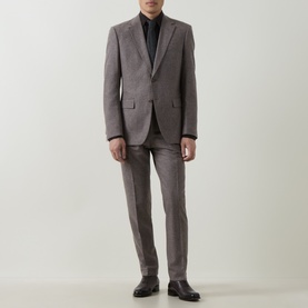 Model wearing Hugo Boss dark brown wool-blend suit with slim-fit trousers, styled with black shirt and dark leather shoes.