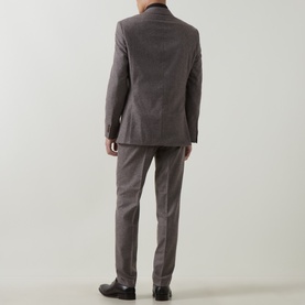 Model wearing Hugo Boss dark brown wool-blend suit, rear view, styled with black leather dress shoes.