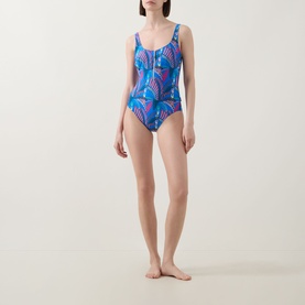 Model wearing Anita Elouise Floral Zip Swimsuit in Sardinia, featuring blue floral print, round neck, shoulder straps and zip neckline detail.