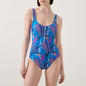 Model wearing Anita Elouise Floral Zip Swimsuit in Sardinia blue geometric print with round neck, shoulder straps and zip neckline detail.