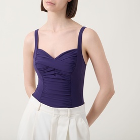 Model wearing Anita Michelle Ruched One-Piece Swimsuit in Blackberry, sweetheart neckline, ruched front wrap drape, adjustable straps, styled with
