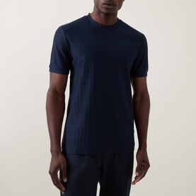 Model wearing Boss Black Casual H-Thompson318 Tonal Stripe T-Shirt in dark blue, crew neck, short sleeves, with matching navy trousers