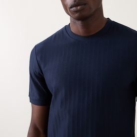 Model wearing Boss Black Casual H-Thompson318 Tonal Stripe T-Shirt in dark blue, crew neck with subtle vertical stripes, short sleeves visible.