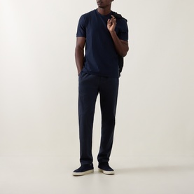 Model wearing Boss Black Casual H-Thompson318 Dark Blue T-Shirt, styled with navy trousers and cream trainers