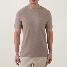Model wearing Boss Black Casual Open Brown crew neck T-shirt with textured pattern, styled with beige shorts