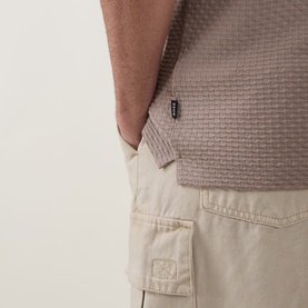 Model wearing Boss Black Casual Open Brown crew neck T-shirt with textured knit pattern, styled with stone cargo shorts.