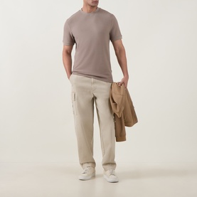 Model wearing Boss Black Casual Open Brown crew neck T-shirt with beige cargo trousers, carrying a tan jacket.