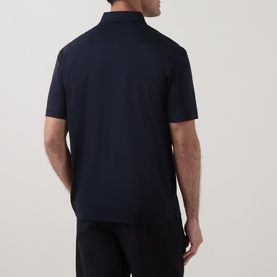 Model wearing Boss Black Casual C-Parris Double B Logo Polo Shirt in dark blue cotton, rear view showing straight hemline and short sleeves.