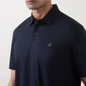 Model wearing Boss Black Casual C-Parris Double B Logo Polo Shirt in dark blue with polo collar and small logo badge detail