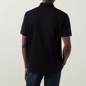 Model wearing Boss Black Casual black cotton polo shirt, rear view, styled with dark jeans