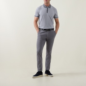 Model wearing Boss Black Casual Dark Grey slim-fit trousers, styled with a grey polo shirt and navy suede trainers.