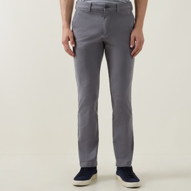 Model wearing Boss Black Casual dark grey cotton-blend chino trousers, styled with navy suede trainers.