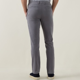 Model wearing Boss Black Casual dark grey slim-fit chino trousers, rear view, styled with navy loafers