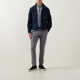 Model wearing Boss Black Casual Dark Grey slim-fit trousers styled with navy zip-up jacket, grey polo shirt and navy suede shoes.