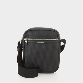 Calvin Klein black crossbody bag with silver zip, front pocket, textured finish, and adjustable black shoulder strap