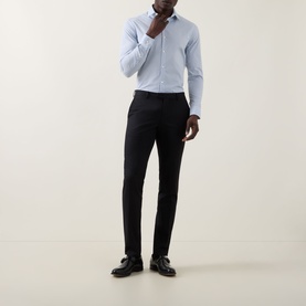 Model wearing Calvin Klein The Poplin Dotted Shirt in Blue Dot, slim fit with single cuffs, styled with black trousers and dress shoes.