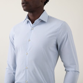 Model wearing Calvin Klein The Poplin Dotted Shirt in Blue Dot, slim fit with single cuffs, subtle dot pattern, and button fastening at collar.