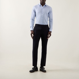 Model wearing Calvin Klein Check Slim Fit Non-Iron Shirt in blue check with slim black trousers and black leather shoes.