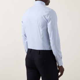 Model wearing Calvin Klein Blue Check Slim Fit Non-Iron Shirt, back view, styled with navy trousers, single cuff, long sleeves visible.