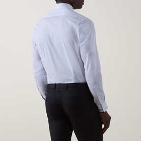Model wearing Calvin Klein Geometric Single-Cuff Shirt in Blue Geo, rear view, slim fit, long sleeves, styled with black trousers.