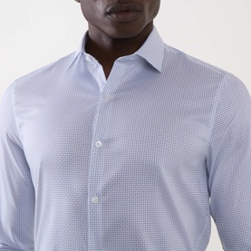 Model wearing Calvin Klein Geometric Single-Cuff Shirt in Blue Geo, showing classic collar and slim-fit silhouette with geometric print detail.