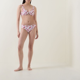 Model wearing Seafolly Summer Chintz Retro Bikini Bottoms in ecru floral print, low-rise with wide side panels, styled with matching bikini top.