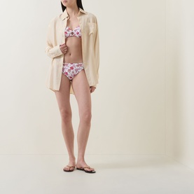 Model wearing Seafolly Summer Chintz Retro Bikini Bottoms in Ecru floral print, styled with matching bikini top and cream oversized shirt.