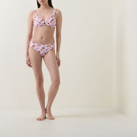 Model wearing Seafolly ecru floral bikini top with matching floral bikini briefs, pink and red flower print throughout