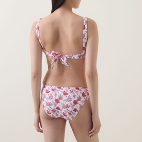 Model wearing Seafolly ecru floral bikini top with bow back tie detail, paired with matching floral bikini bottoms