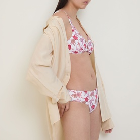 Model wearing Seafolly ecru floral bikini top with matching briefs, styled with a loose cream open-front cover-up