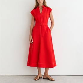 Model wearing Reiss red midi dress with V-neck, cap sleeves, belted waist, and contrast stitching hem, styled with tan flat sandals.