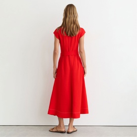 Model wearing Reiss red midi dress with cap sleeves, fitted waist, and full A-line skirt with contrast stitching hem detail, back view.